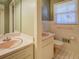 Pink bathroom with tile floor, vanity, toilet, and window at 8450 Union Grove Rd, Lithonia, GA 30058