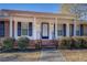 Front porch with brick steps, white siding, and black shutters at 8450 Union Grove Rd, Lithonia, GA 30058