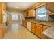 Spacious kitchen with wood cabinetry, granite countertops, and white appliances at 8450 Union Grove Rd, Lithonia, GA 30058