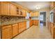 Spacious kitchen with wood cabinets, granite countertops, and tile backsplash at 8450 Union Grove Rd, Lithonia, GA 30058