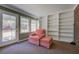 Sunroom or den with built-in bookshelves and a comfortable chair at 8450 Union Grove Rd, Lithonia, GA 30058