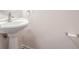 Powder room with pedestal sink, brushed nickel faucet, and simple decor at 1547 Welch Ct, Suwanee, GA 30024
