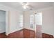 Bedroom with double french doors, closet, chair rail, and wood-look floors at 1547 Welch Ct, Suwanee, GA 30024