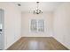 Elegant dining room with chair rail, chandelier, and large window at 1547 Welch Ct, Suwanee, GA 30024