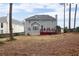 Two-story home with gray siding, red deck, and fenced backyard at 1547 Welch Ct, Suwanee, GA 30024