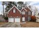 Charming two-story brick home with a two-car garage and landscaped yard at 1547 Welch Ct, Suwanee, GA 30024
