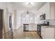 Modern kitchen with white cabinets, stainless steel appliances, and granite countertops at 1547 Welch Ct, Suwanee, GA 30024