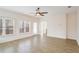 Bright living room with wood-look floors, ceiling fan, and view of adjacent kitchen at 1547 Welch Ct, Suwanee, GA 30024