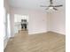 Open living room with wood-look floors and view of the kitchen at 1547 Welch Ct, Suwanee, GA 30024