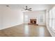 Cozy living room with brick fireplace, wood-look floors, and large windows at 1547 Welch Ct, Suwanee, GA 30024