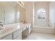 Main bathroom with double vanity, soaking tub, and separate shower at 1547 Welch Ct, Suwanee, GA 30024