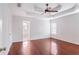 Large main bedroom with tray ceiling, ceiling fan, and ensuite bathroom access at 1547 Welch Ct, Suwanee, GA 30024