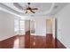 Spacious main bedroom with french doors, ceiling fan, and walk-in closet at 1547 Welch Ct, Suwanee, GA 30024
