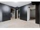 Unfinished basement with black painted walls and doorways to additional rooms at 1121 Kelvington Way, Lilburn, GA 30047