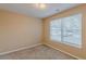 Empty bedroom with neutral colored walls, carpet flooring, and window at 139 Hampton Oaks Dr, Hampton, GA 30228