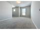 Spacious bedroom with gray carpet and multiple windows at 2560 Quarterdeck Dr, Cumming, GA 30041