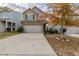 Two-story house with gray siding, two-car garage, and a landscaped yard at 5537 Union Pointe Pl, Union City, GA 30291