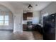 Modern kitchen with dark cabinets, granite countertops, and black appliances at 5537 Union Pointe Pl, Union City, GA 30291