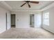 Main bedroom with ceiling fan and carpet, open to bathroom at 5537 Union Pointe Pl, Union City, GA 30291