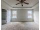 Main bedroom with ceiling fan, carpet, and access to bathroom at 5537 Union Pointe Pl, Union City, GA 30291