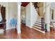 Grand foyer with hardwood floors, elegant staircase, and decorative columns at 3213 Ashmore Ct, Conyers, GA 30094