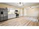 Kitchen with white cabinets, stainless steel appliances, and wood-look floor at 345 Panhandle Pl, Hampton, GA 30228