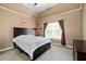 Spacious bedroom with a king-size bed and large window at 6318 Sunshine Cove Ln, Buford, GA 30518