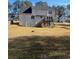 Two-story house with backyard, deck, and adjacent homes visible at 1276 Huntington Place Cir, Lithonia, GA 30058