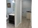 Clean bathroom with dark vanity and adjacent laundry area at 1276 Huntington Place Cir, Lithonia, GA 30058