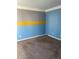 Spacious bedroom with gray, yellow, and blue walls at 1276 Huntington Place Cir, Lithonia, GA 30058