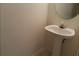 Half-bath with a pedestal sink and oval mirror at 2920 Vining Ridge Ter, Decatur, GA 30034