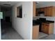 View of the kitchen from the hallway, showing oak cabinets and black appliances at 2920 Vining Ridge Ter, Decatur, GA 30034