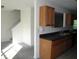 Kitchen with oak cabinets, black countertops, and a view of the staircase at 2920 Vining Ridge Ter, Decatur, GA 30034