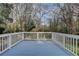 Spacious deck with white railing and a view of the wooded backyard at 3479 Chestnut Dr, Atlanta, GA 30340