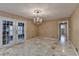 Dining room with chandelier, marble tile floor, and French doors at 3479 Chestnut Dr, Atlanta, GA 30340