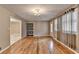 Dining room with hardwood floors, built-in shelving, and access to another room at 3479 Chestnut Dr, Atlanta, GA 30340