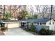 Charming two-story home with attached garage, landscaped yard, and trees at 3479 Chestnut Dr, Atlanta, GA 30340