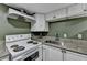 Kitchen with white cabinets, granite countertops, and black appliances at 3479 Chestnut Dr, Atlanta, GA 30340