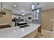 Modern kitchen with quartz countertops, white cabinets, and stainless steel appliances at 3479 Chestnut Dr, Atlanta, GA 30340