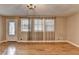 Spacious living room with hardwood floors, large windows, and elegant chandelier at 3479 Chestnut Dr, Atlanta, GA 30340