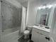 Modern bathroom with tiled shower, white vanity, and marble-look tile floor at 3963 Allegretto Cir, Atlanta, GA 30339