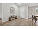 Bright foyer with wood-look flooring, a decorative mirror, and access to the dining area at 7430 Country Creek Dr, Cumming, GA 30028