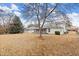 View of the backyard from the side, showcasing the screened porch and dry winter grass at 4907 Wilkins Station Dr, Decatur, GA 30035