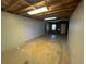 Partially finished basement with painted walls and flooring at 125 Woodhawk Ln, Stockbridge, GA 30281