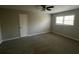 Spacious bedroom with neutral walls, plush carpeting, and a ceiling fan at 125 Woodhawk Ln, Stockbridge, GA 30281
