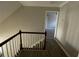 Upstairs hallway with hardwood floors and wooden railing at 125 Woodhawk Ln, Stockbridge, GA 30281