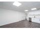 Open basement area with white walls and dark wood-style flooring at 5105 Wright Bridge Road, Cumming, GA 30028