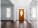 Bright foyer with wood-look floors, white walls, and a beautiful wooden front door at 5105 Wright Bridge Road, Cumming, GA 30028