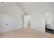 Simple bedroom with light wood floors and access to bathroom at 3707 Randall Mill Nw Rd, Atlanta, GA 30327