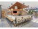 Stylish outdoor bar with seating, pendant lighting, and TVs at 40 12Th Ne St # 1904, Atlanta, GA 30309